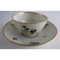 Worcester Tea Bowl and Saucer, Decorated in Underglaze Blue with Formal Flowers, Honey Gold Leaves and Stems, Gold Dentil Rim and Base, c1785