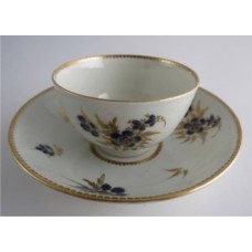 Worcester Tea Bowl and Saucer, Decorated in Underglaze Blue with Formal Flowers, Honey Gold Leaves and Stems, Gold Dentil Rim and Base, c1785