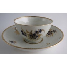 Worcester Tea Bowl and Saucer, Decorated in Underglaze Blue with Formal Flowers, Honey Gold Leaves and Stems, Gold Dentil Rim and Base, c1785