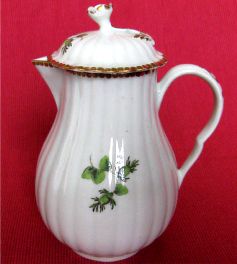Worcester Pear Shaped Milk Jug and Cover, moulded fluted body, shallow domed cover with flower finial. Decorated in green monochrome with flowers and fruit, c1775
