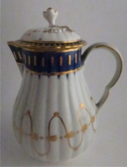 Worcester Pear Shaped Milk Jug and Cover, moulded fluted body, shallow domed cover with flower finial. Decorated in underglaze cobalt blue and rich gilding, c1775