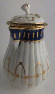 Worcester Pear Shaped Milk Jug and Cover, moulded fluted body, shallow domed cover with flower finial. Decorated in underglaze cobalt blue and rich gilding, c1775