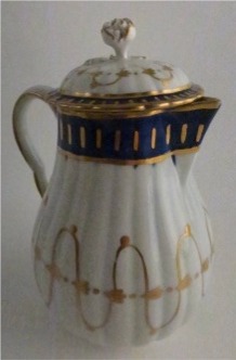 Worcester Pear Shaped Milk Jug and Cover, moulded fluted body, shallow domed cover with flower finial. Decorated in underglaze cobalt blue and rich gilding, c1775