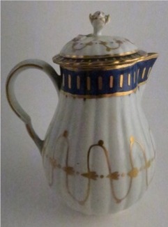 Worcester Pear Shaped Milk Jug and Cover, moulded fluted body, shallow domed cover with flower finial. Decorated in underglaze cobalt blue and rich gilding, c1775