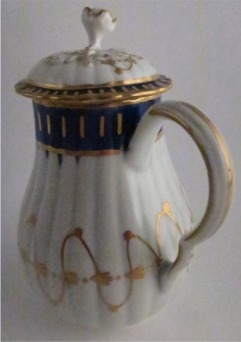 Worcester Pear Shaped Milk Jug and Cover, moulded fluted body, shallow domed cover with flower finial. Decorated in underglaze cobalt blue and rich gilding, c1775