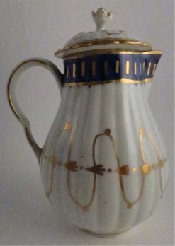 Worcester Pear Shaped Milk Jug and Cover, moulded fluted body, shallow domed cover with flower finial. Decorated in underglaze cobalt blue and rich gilding, c1775