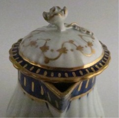 Worcester Pear Shaped Milk Jug and Cover, moulded fluted body, shallow domed cover with flower finial. Decorated in underglaze cobalt blue and rich gilding, c1775