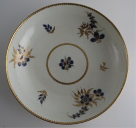 Worcester 'Bread and Butter' or 'Cake' Plate, Decorated in Underglaze Blue with Formal Flowers, Honey Gold Leaves and Stems, Gold Dentil Rim, c1785