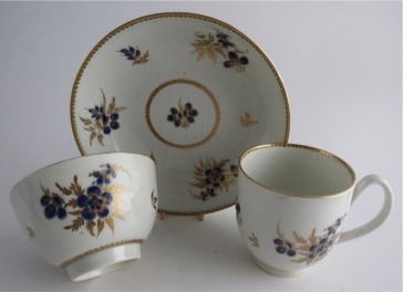 Worcester Trio, Decorated in Underglaze Blue with Formal Flowers, Honey Gold Leaves and Stems, Gold Dentil Rim and Base, c1785