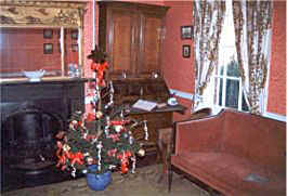 Parlour in Dickens birthpace showing an oak bureau bookcase