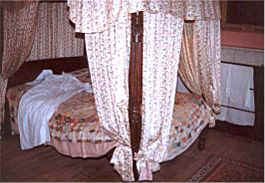 Four poster bed in the bedroom in which Dickens was born in 1812