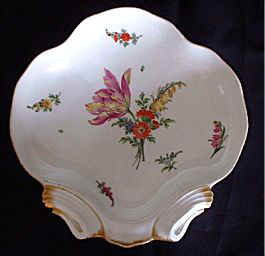 This dessert dish, made by 'Marcolini' Meissen has a bouquet which includes a striking and rather jazzy yellow and red Tulip.